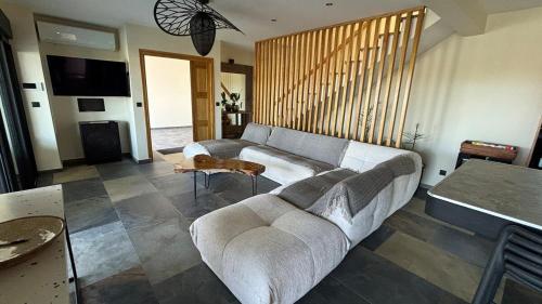 a living room with a couch and a table at Blue Naiade Villa zen and cosy in Étang-Salé