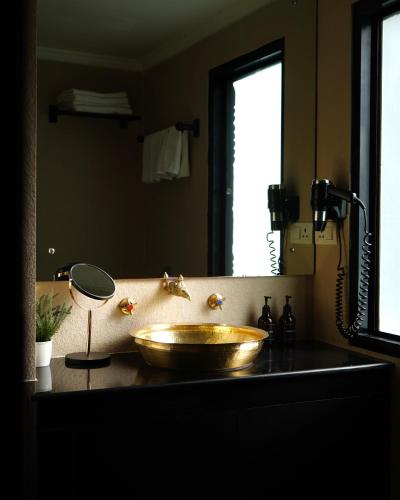 a bathroom with a bowl sink and a mirror at Dalai-La Boutique Hotel in Kathmandu