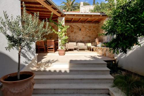 a patio with stairs and a table and chairs at House Corte in Vis