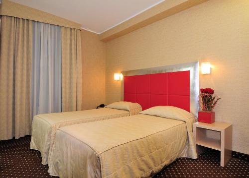 Postel nebo postele na pokoji v ubytování Hotel Susa