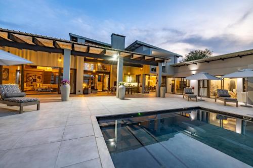 an image of a house with a swimming pool at Ingwenkala Luxury Safari Lodge in Hoedspruit
