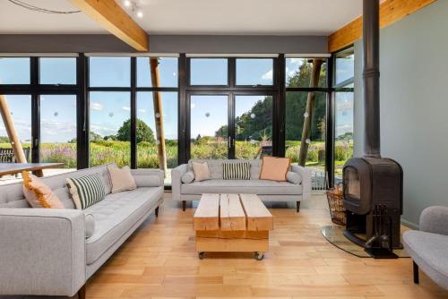 a living room with couches and a fire place at Yorkshire Dales Lodge 4 by Together Travel - 3-Bed Family Retreat in Richmond