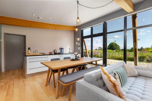 a kitchen and living room with a couch and a table at Yorkshire Dales Lodge 4 by Together Travel - 3-Bed Family Retreat in Richmond