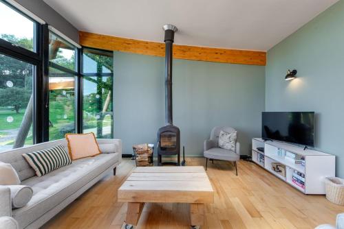 a living room with a couch and a fireplace at Yorkshire Dales Lodge 4 by Together Travel - 3-Bed Family Retreat in Richmond