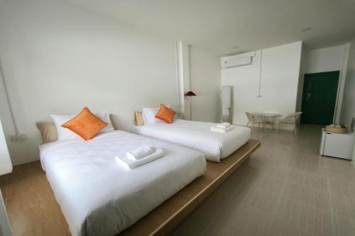 two beds sitting next to each other in a room at Ban Ye in Phayao