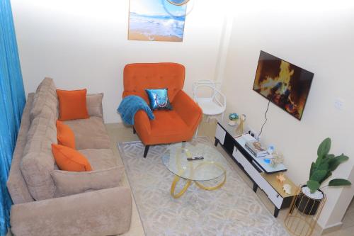 a living room with a couch and a chair at The Swanky Suite, Kamakis in Ruiru
