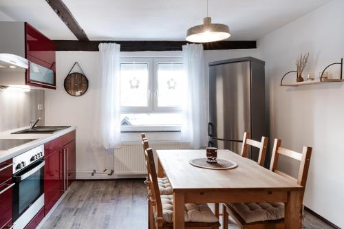 a kitchen with a wooden table and a dining room at 4 Bett Ferienwohnung Weintraube in Wengenroth