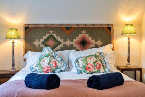 a bed with two pillows on it with two lamps at Finest Retreats - Whitley in Molland