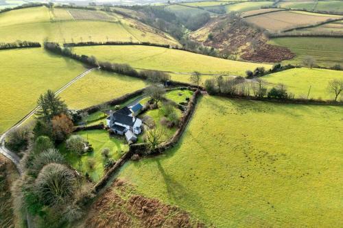 an aerial view of a house in a field at Finest Retreats - Whitley in Molland