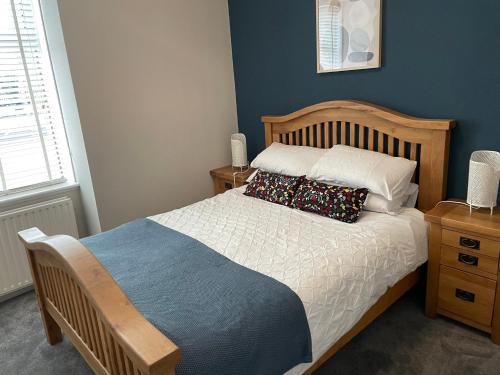 a bedroom with a bed with two pillows on it at Cosy James Street Park 2 bedroom, ground floor apartment, garden in Helensburgh