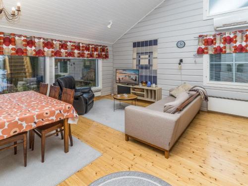 a living room with a couch and a table at Holiday Home Onnimanni by Interhome in Kuusamo