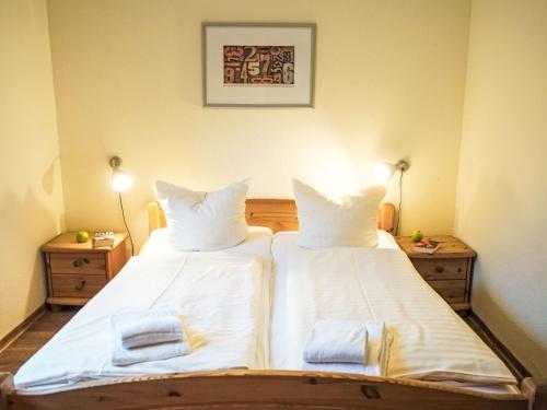 a bedroom with two beds with white sheets and towels at Holiday Home Müritz Ferienpark Röbel-59 by Interhome in Röbel