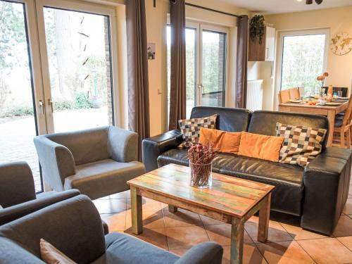 a living room with couches and a coffee table at Holiday Home Müritz Ferienpark Röbel-59 by Interhome in Röbel