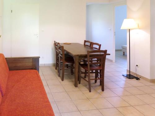 une salle à manger avec une table et des chaises en bois dans l'établissement Apartment Le Domaine de Claire Rive-2 by Interhome, à Prayssac