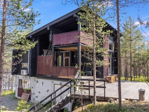 a house with a wrap around porch and a deck at Holiday Home Matkajoentie 4b by Interhome in Kuusamo