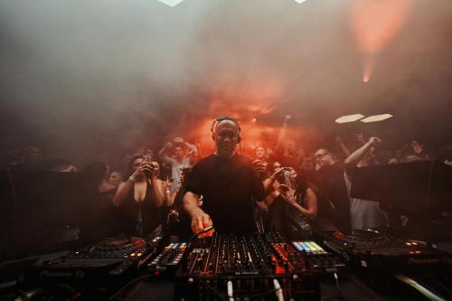 a dj in front of a crowd of people at Destino Five Ibiza - 5-Star Grand Luxe Resort in Talamanca