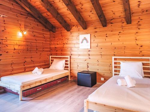 a room with two beds in a wooden cabin at Holiday Home Echo du Mihi by Interhome in Nendaz