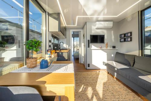 a living room with a couch and a table at The Homeboat Company Albufeira in Albufeira