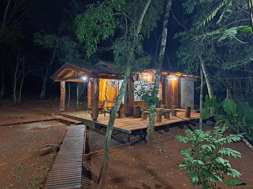 a wooden cabin in the woods at night at Cabañas Libertad en Misiones in Puerto Bossetti