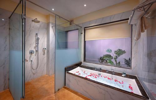 un bagno con doccia e vasca da bagno di The Tigress, Ranthambore a Sawai Madhopur
