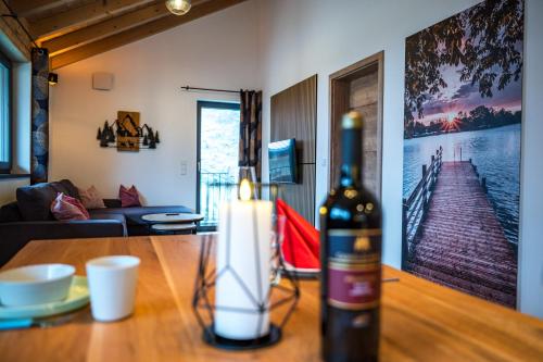 a bottle of wine on a table in a living room at Ferienwohnung Kamml in Waging am See