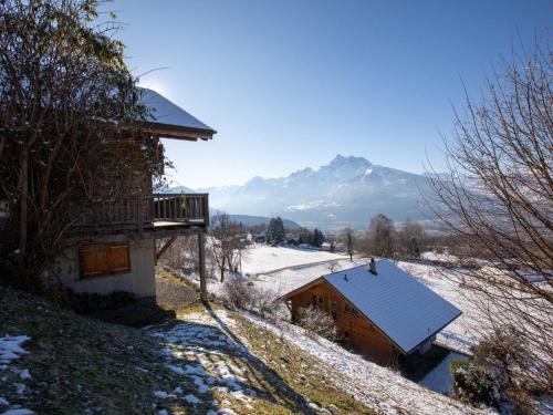 a house with a balcony and a snow covered roof at Chalet Chalet Le Hameau by Interhome in Huémoz