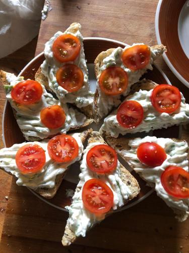 a plate of bread with tomatoes on it at Hostinec U PUDILŮ in Soběšín