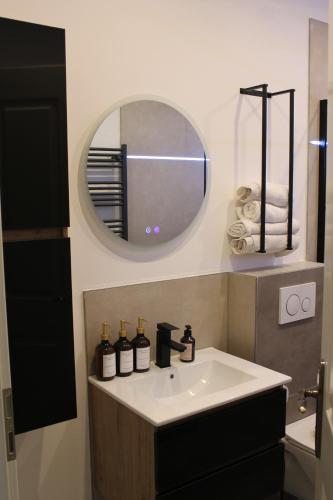 a bathroom with a sink and a mirror at Hotel Via Vita in Treuchtlingen