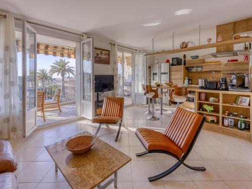 un salon avec un canapé, des chaises et une table dans l'établissement Apartment Les Palmiers-4 by Interhome, à Saint-Cyr-sur-Mer