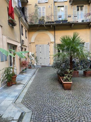 a courtyard with potted plants in front of a building at Angolo di Viola in Turin