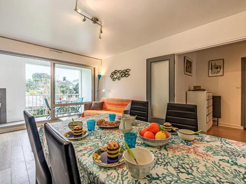 a dining room with a table with food on it at Apartment Le Zal-4 by Interhome in Quiberon