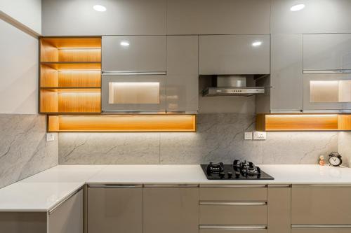 a kitchen with white countertops and stainless steel appliances at 2BHK Furnished SeaView Apartment in Kaniyapuram