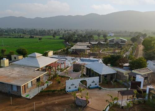 an aerial view of a village with houses and a field at The Grand Sariska Baagh in Tehla