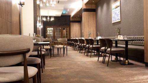 a row of tables and chairs in a restaurant at Doubletree By Hilton Kars Sarikamis in Sarıkamıs