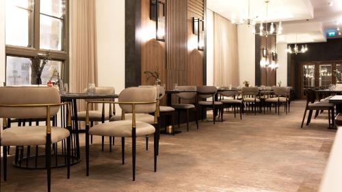 a row of tables and chairs in a restaurant at Doubletree By Hilton Kars Sarikamis in Sarıkamıs