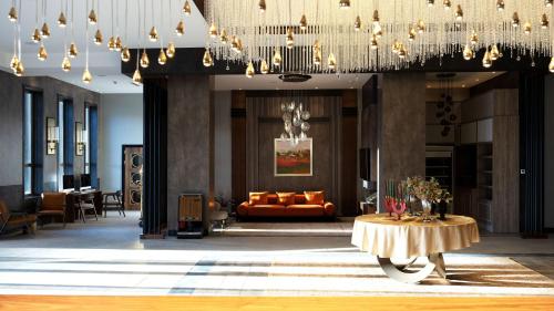 a lobby of a hotel with a couch and a table at Doubletree By Hilton Kars Sarikamis in Sarıkamıs