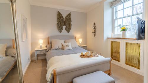 a small bedroom with a bed and a window at Antelope Cottage in Northleach