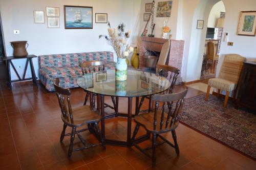 a dining room with a glass table and chairs at L'Oasi della Fonte in Albanella