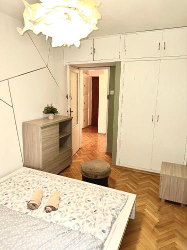 a bedroom with a bed with two slippers on it at Intercontinental Escape in Warsaw