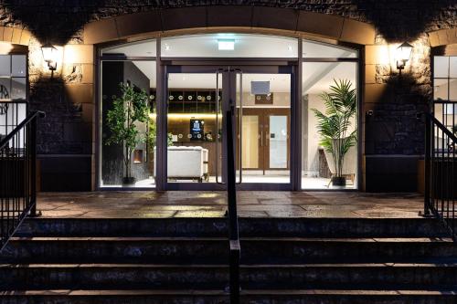 an entrance to a building with stairs in front at Rock Mill 1 Bed Apartment 13 in Stoney Middleton
