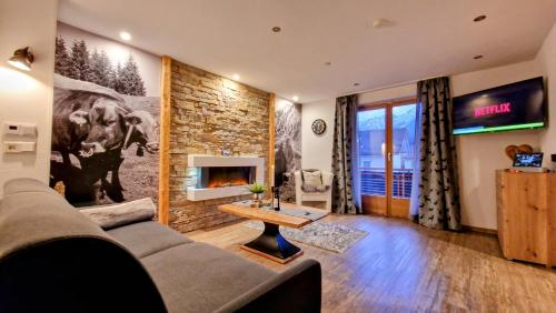 a living room with a couch and a fireplace at Ferienwohnungen Wolf - zentral in Pfronten mit Panorama-Alpenblick und ruhiger Lage in Pfronten
