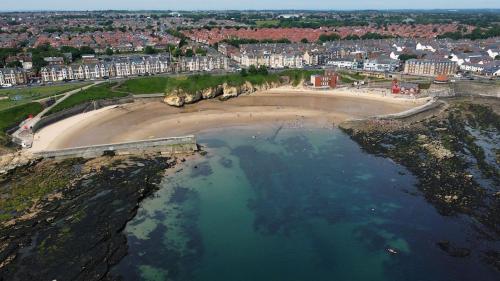 an aerial view of a beach with buildings and houses at Boho Bay Two - Seaside Escape in Cullercoats