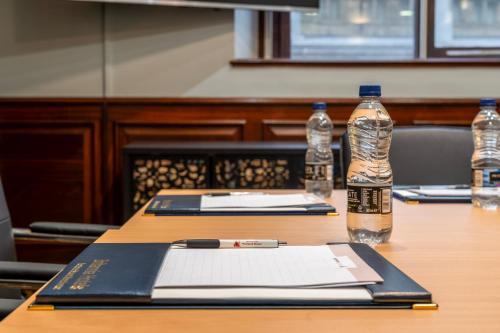 a table with two bottles of water and a book at Britannia Hotel City Centre Manchester in Manchester
