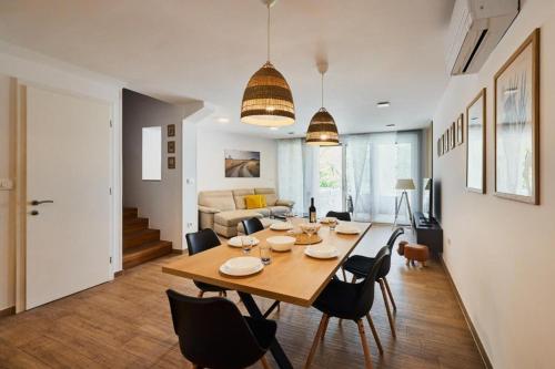 a dining room and living room with a table and chairs at Vipava River Retreat - Happy Rentals in Vipava
