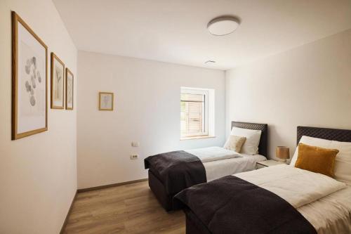 a bedroom with two beds and a window at Vipava River Retreat - Happy Rentals in Vipava