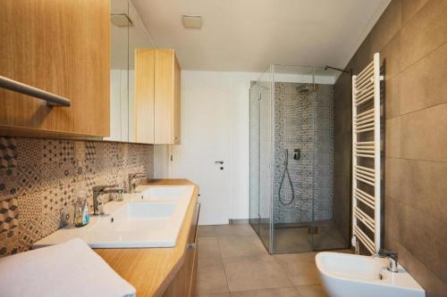 a bathroom with two sinks and a shower at Vipava River Retreat - Happy Rentals in Vipava