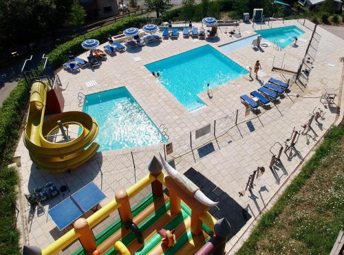 an overhead view of a swimming pool with a slide at Camping le Mas des Sedaries in Villefort