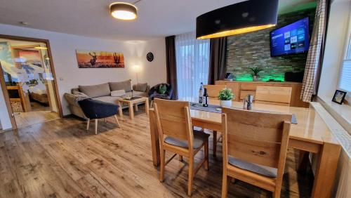 a kitchen and living room with a table and a couch at Ferienwohnungen Wolf - zentral in Pfronten mit Panorama-Alpenblick und ruhiger Lage in Pfronten