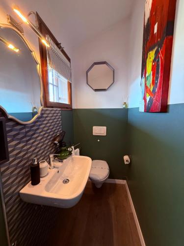 a bathroom with a sink and a toilet at Palazzina300 in Treviso