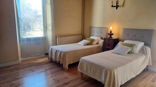 a room with two beds and a window at Maison charmante à Plan-de-Baix avec vue montagne. in Plan-de-Baix